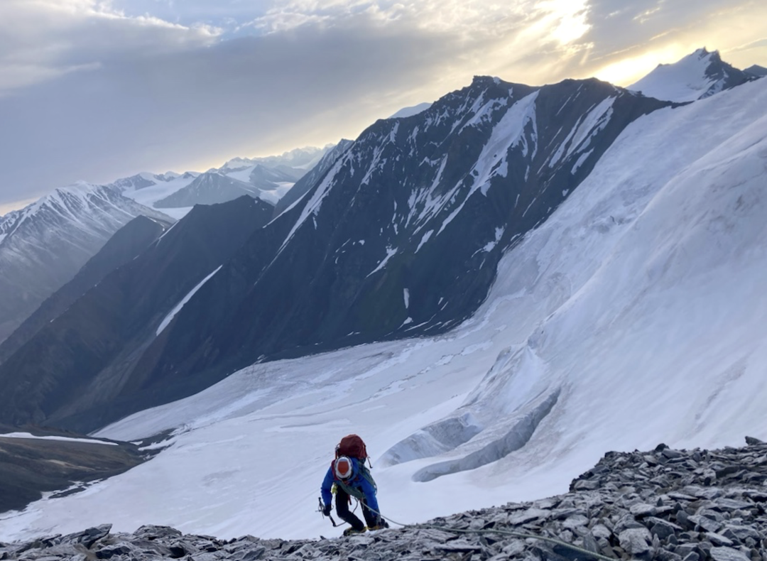 Isabel Jones emerging onto the summit ridge of Peak 4,660m in the Ak-Shyyrak Range.