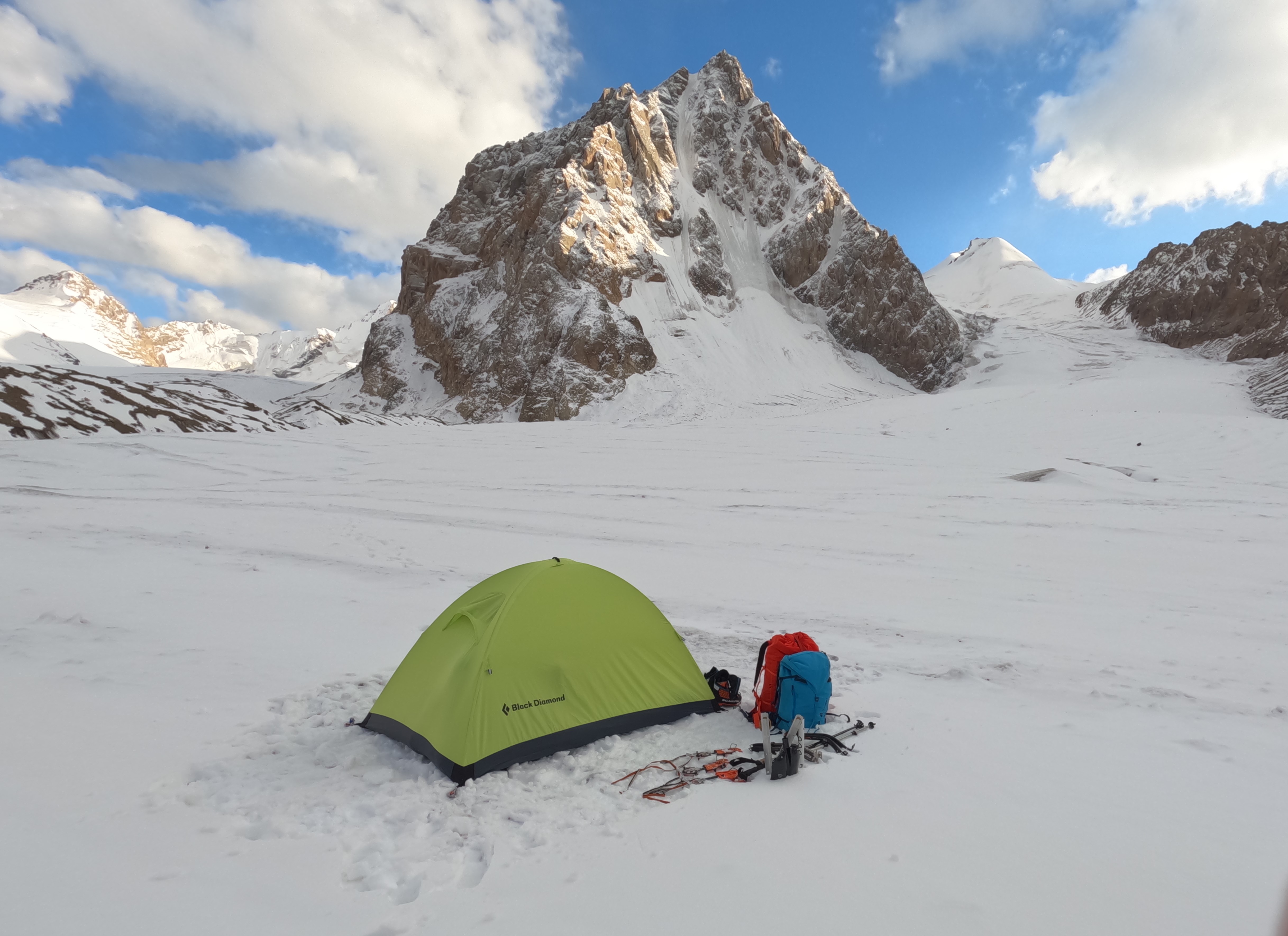 Camp on the central Djangartynbashi Glacier below Howard Bury Peak. The small top named Line Peak, climbed in 2024, is visible to the right; it was accessed from the western arm of the Djangartynbashi, off-picture to the right. 
