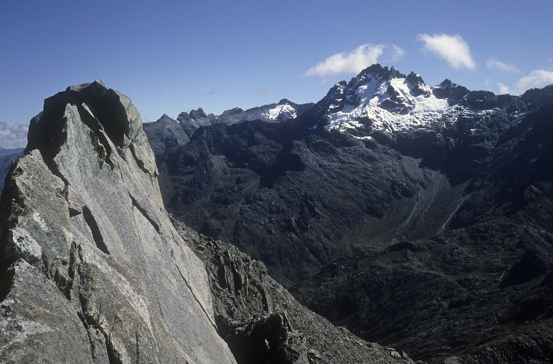 Pico Bolívar from the Toro-León traverse to the west in December 1985. The line climbed that year diagonals up and right in the center of the face. The glaciers are now all gone. Right of center and below the mountain can be seen the upper reaches of the Espejo Valley. 
