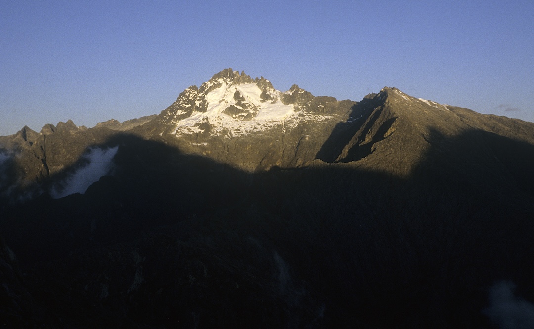 Sunset on the west face of Pico Bolívar seen from the León ridge in December 1985. The line climbed that year diagonals up and right in the center of the face. Forty years later, the glaciers have all melted. 
