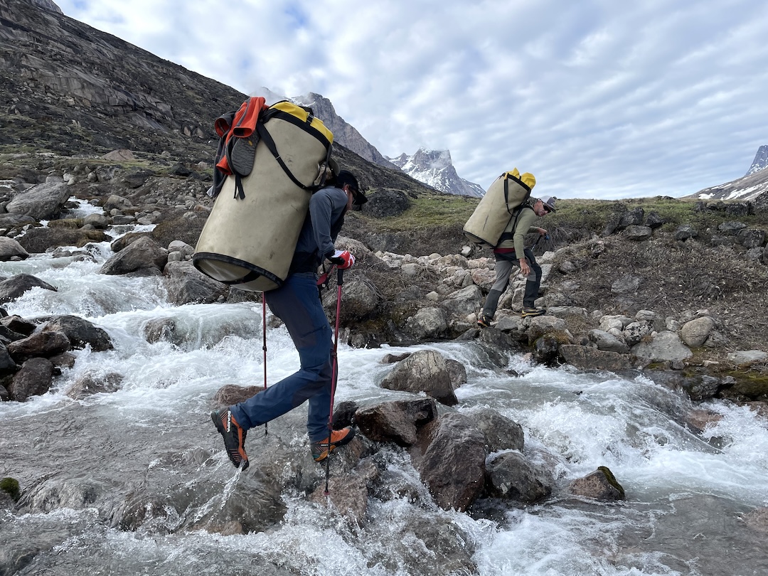 Moving loads up the Weasel River Valley. Even with gear cached near the top of the valley in advance of the expedition, it took six days of hiking under haulbags weighing up to 90 pounds to reach the team’s first base camp. 