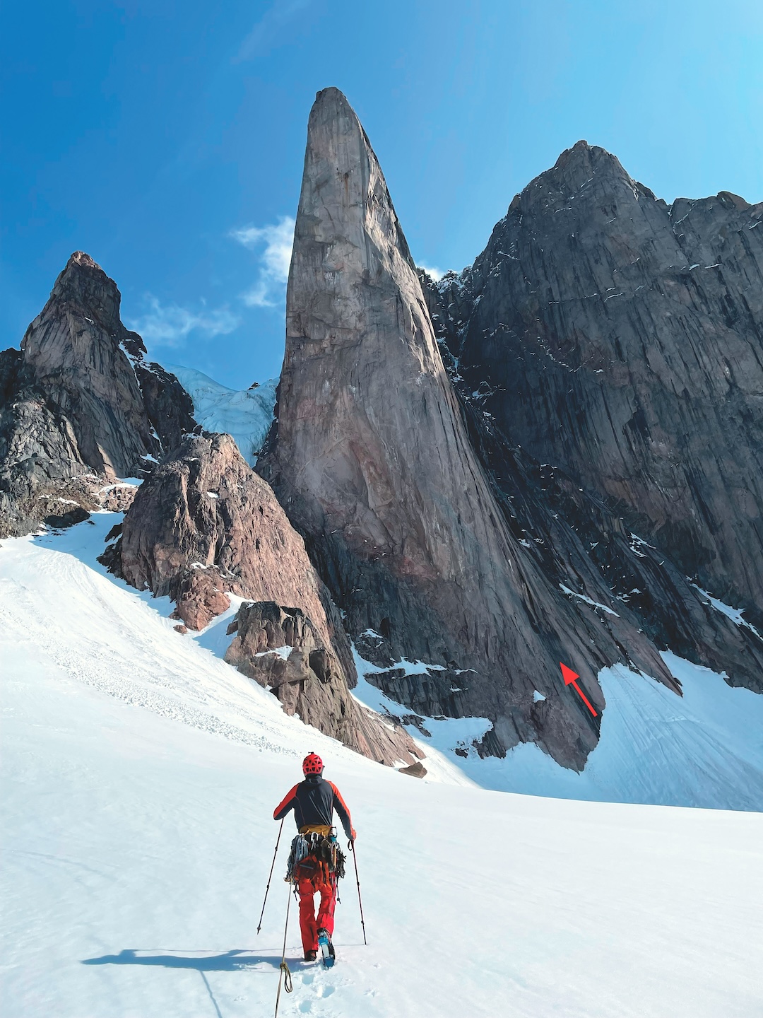 Approaching the 2,500-foot west face of Frigga I. The arrow marks the start of Ragnarok, which continued directly up the right side of the face. The only prior route up the west face was Slith the Frightful, on the left side, climbed in 1996  by Wally Barker and John Rzeczycki.