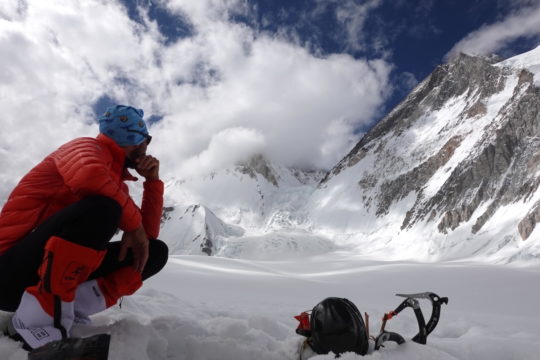 Aleš Česen contemplates the rocky west ridge of Gasherbrum III, seen in profile, from the South Gasherbrum Glacier. The ridge gains about 950 meters from the G-III/G-IV col. 