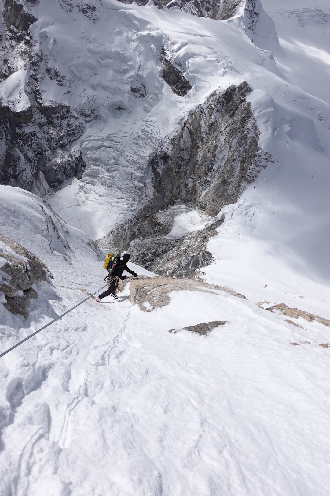Ryan Griffiths rappelling the northwest ridge of Kaqur Kangri, with the icefall on the southeast side of Peak 6,226m behind. The team exited to skier’s left off the glacier below and rappelled back into the valley of their advanced base camp. 