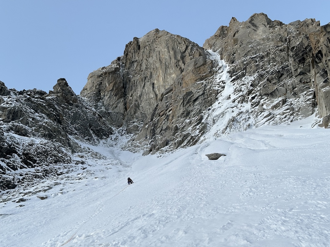 August Franzen starting up Yashkuk Sar on September 19. The climbers angled left up an icy couloir to reach a leftward traverse and moderate mixed terrain, skirting the monolithic rock wall on its left.
