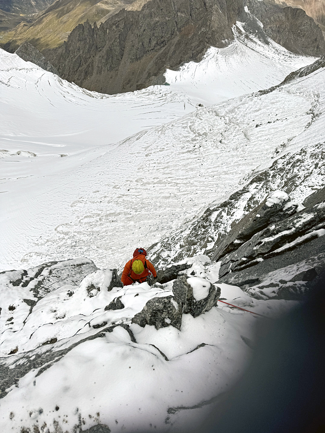 Steep snowed-up ground on the southwest face of Manamcho during the second ascent of the mountain. The Manam Glacier and route of approach lie below. 
