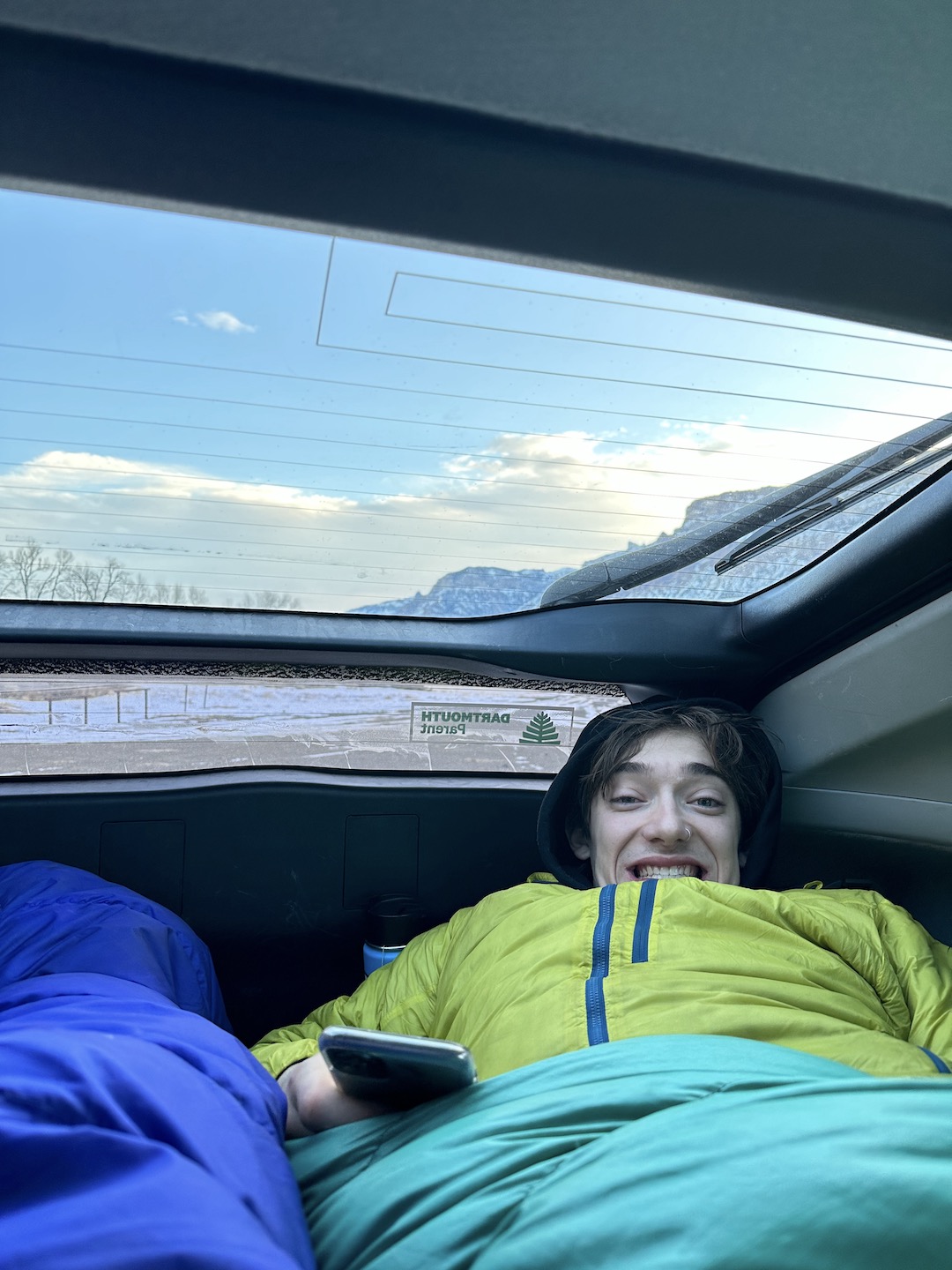 Balin Miller getting cozy in his infamous silver Prius parked in the South Fork of the Shoshone near Cody, Wyoming. 