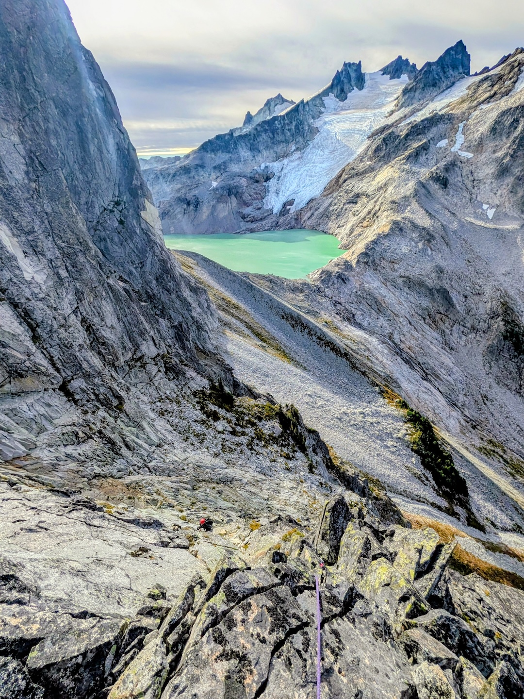 Rolf Larson follows an early pitch on the South Face/Rib Route (III 5.8), with Mt. Daniel and Pea Soup Lake in the background. 