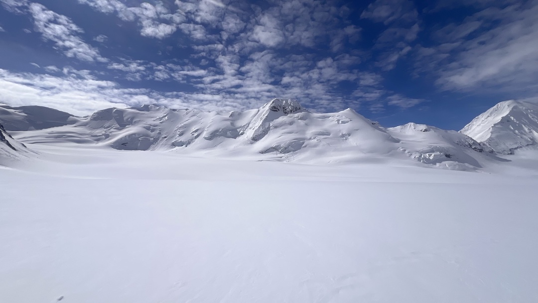 Point 8,350’ (center, rocky summit) from the east branch of the Gillam Glacier. Point 8,092’ is the snowy summit just to the right. 