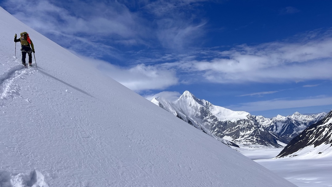 Eli Sturm skinning up Point 8,350’, with the east face of Mt. Hess in the background.