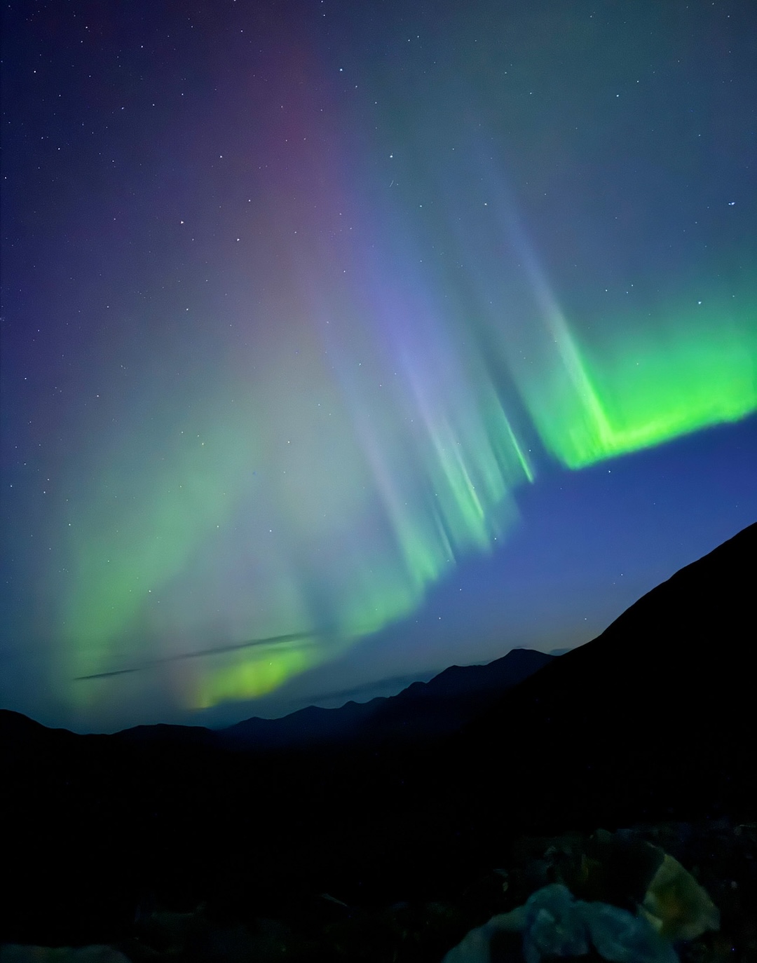 Northern lights dance across the sky at base camp in the Hayes Range. 