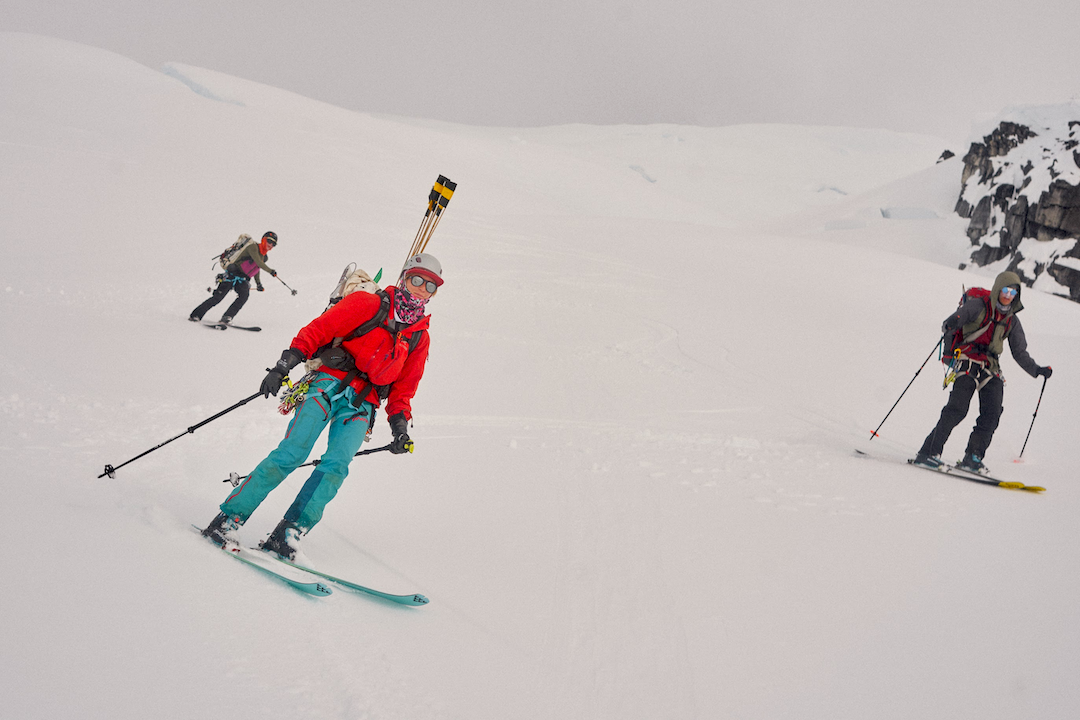 Hazel Probst, Leo Nordman (foreground left and right), and Torin Hooge (background) break through the whiteout after making the first known ascent of Mt. Pratt (7,950’), via the Northwest Glacier (3,500’, moderate snow). 