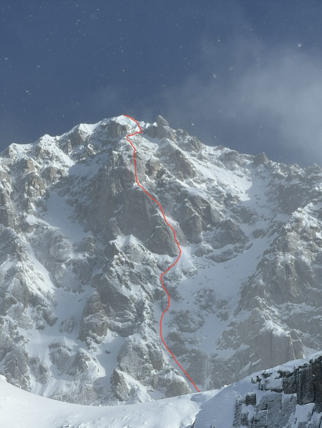 The south face of Mt. Providence (11,200’) in the Alaska Range showing the line of Journey Through the Castle of Providence (1,000m, WI4 M5 5.10 steep snow). Andres Marin, Tad McCrea, and Anna Pfaff made the first ascent of the route in April 2025. It was their second expedition to the mountain. They were stopped just below the summit due to bad weather during a 2024 bid. 