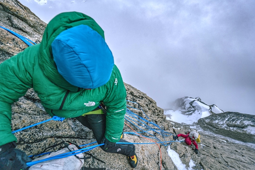 Andres Marin belaying Anna Pfaff on the crux rock pitch of their new route on the south face of Mt. Providence. 