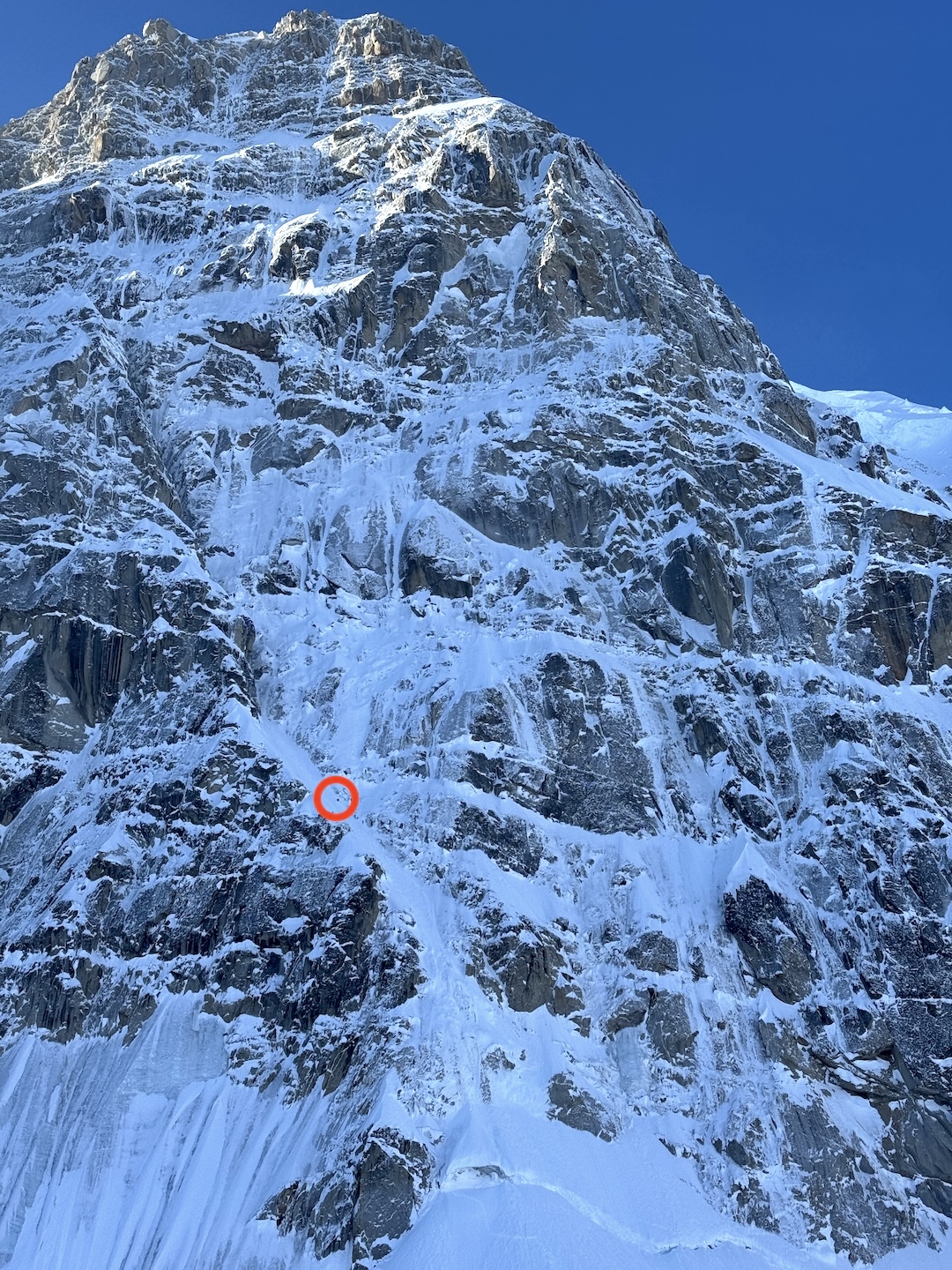 Balin Miller soloing in the lower couloir of the French Route on Begguya’s North Buttress, as seen from the glacier below. Colin Haley completed the first solo ascent of the North Buttress to the summit in 2017 (via a different route). 