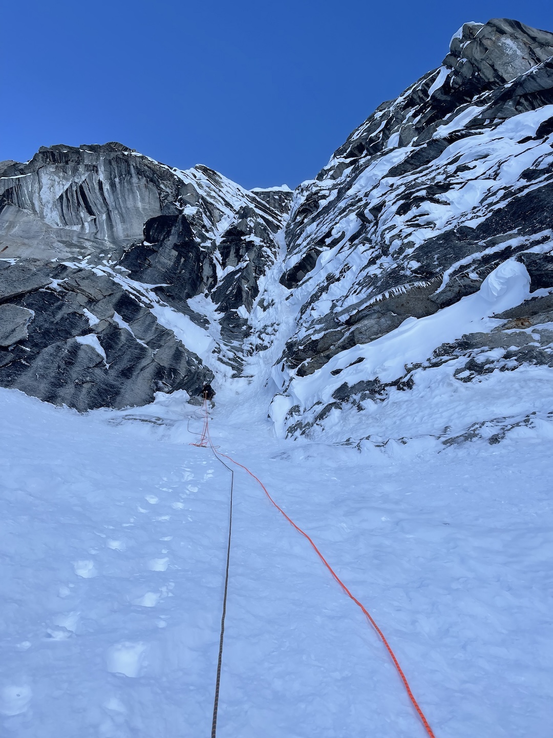 Vincent Landry belays Balin Miller up to the base of the crux pitch of Deprivation on Begguya’s North Buttress on their second attempt at the route. They successfully reached the summit the next day