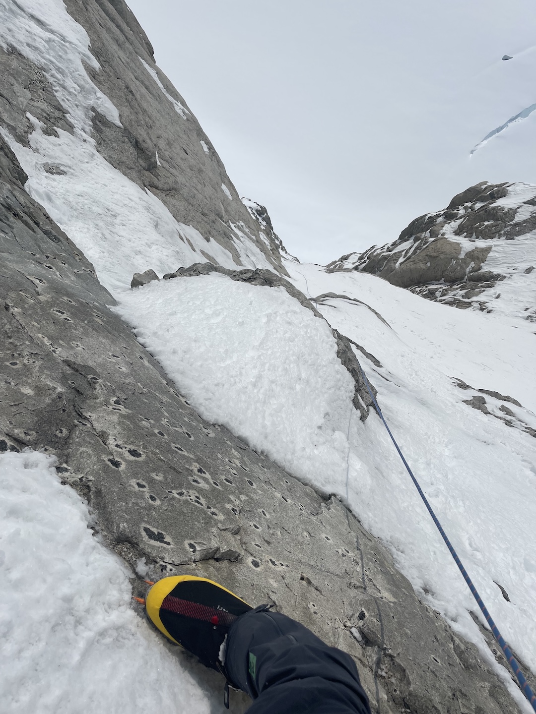 Balin Miller looks down on a slabby traverse low on the Slovak Direct, while making the first solo ascent of the route. He trailed his rope on the route’s difficult pitches but only self-belayed one lead on the climb, an 80-foot rock pitch on day two of the ascent. 