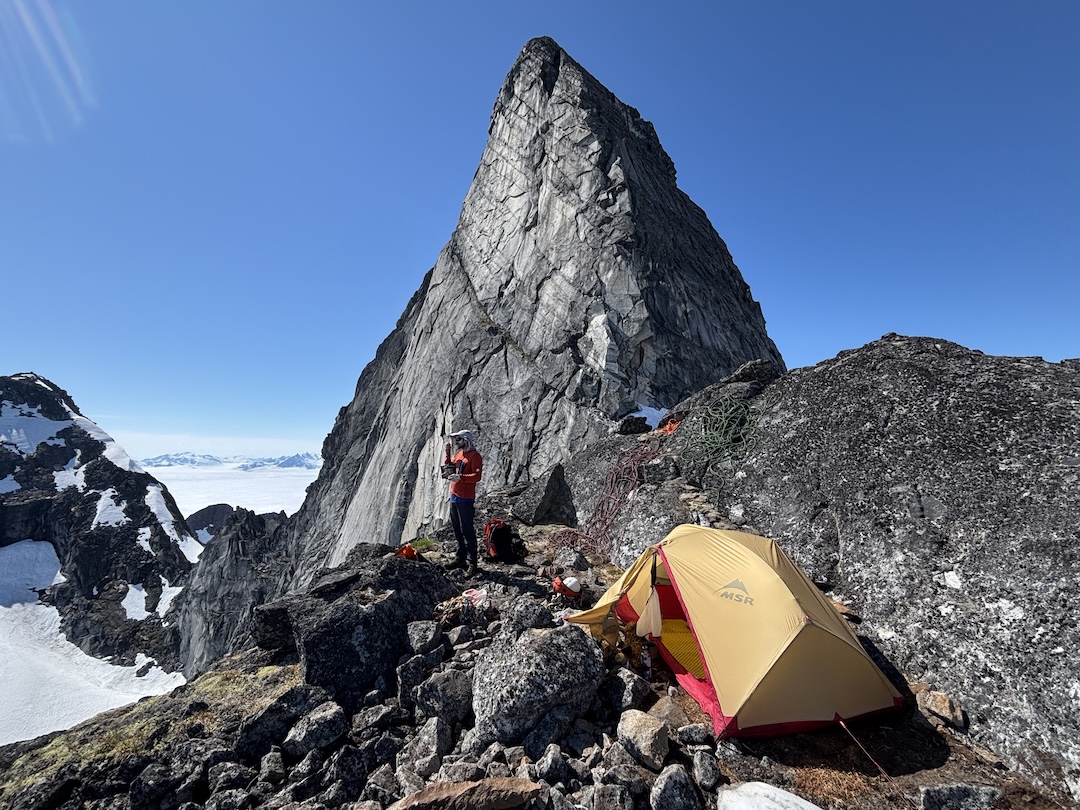 High camp on the east ridge, with the summit headwall behind. The route up the headwall was near the right side of the sunlit face. 