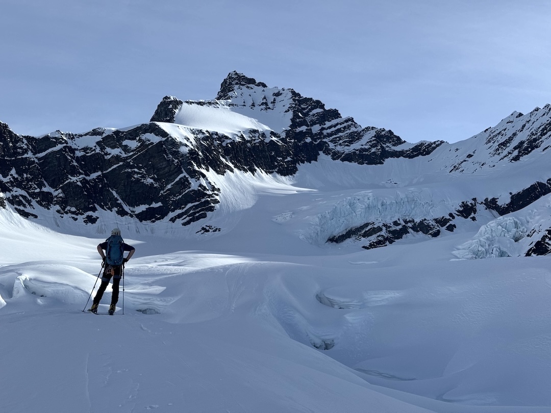 August Franzen approaching the Tusk (6,825’) from the southwest. The south ridge is the right skyline, starting from the prominent saddle. The team descended via the mountain’s southwest side, facing the camera, with two long rappels and downclimbing. 