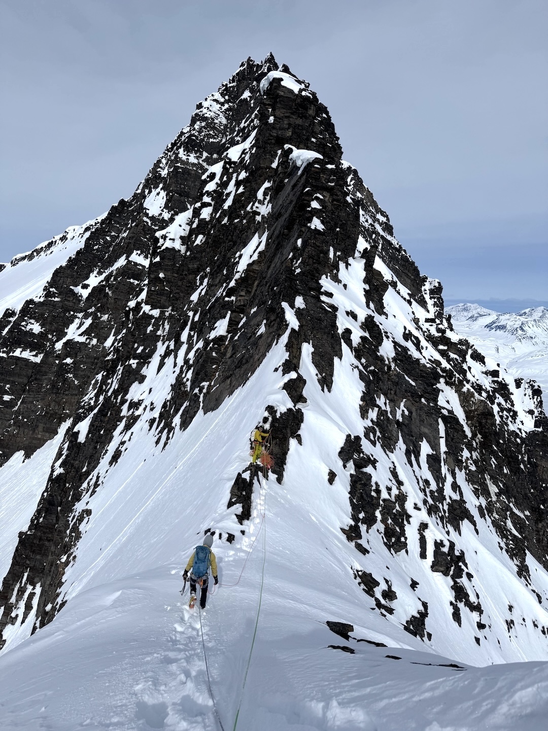 August Franzen and Tim Stephens climbing snow early on the south ridge of the Tusk. 