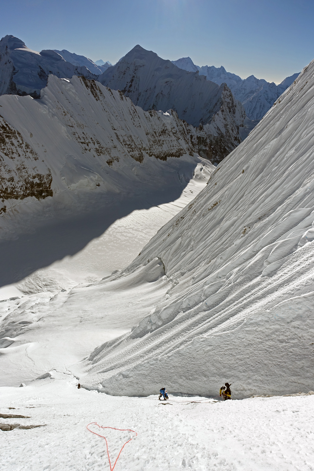In the middle of the east face of Kimshung. The climbers approached up the full length of the Kimshung Glacier below. The pointed summit in shadow is Dragpoche (6,575m).  