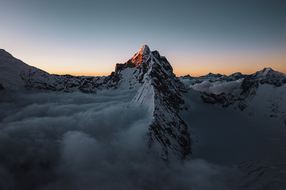 Kimshung from the south at sunset. The first ascensionists climbed from the Kimshung Glacier on the right, but François Cazzanelli’s second of four attempts on the mountain had been via the southwest face to the left. Part of Langtang Lirung’s east face is visible on the far left.  