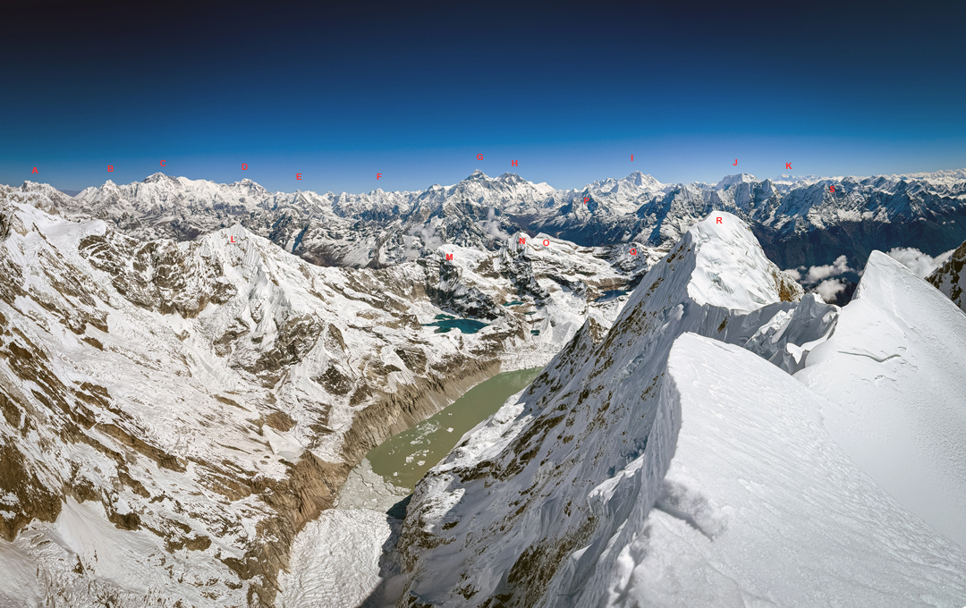 A panoramic view spanning north to east from the summit of Numbur. (A) Lunag. (B) Nangpai Gosum. (C) Cho Oyu. (D) Gyachung Kang. (E) Hungchi. (F) Pumori. (G) Everest. (H) Lhotse. (I) Makalu. (J) Chamlang (K) Kangchenjunga. (L) Tengkangpoche. (M) Kwangde Nup. (N) Kwangde Lho. (O) Kwangde Shar. (P) Ama Dablam. (Q) Nupla West (Peak 5,816m). (R) Khatang. (S) Kusum Kanguru. 