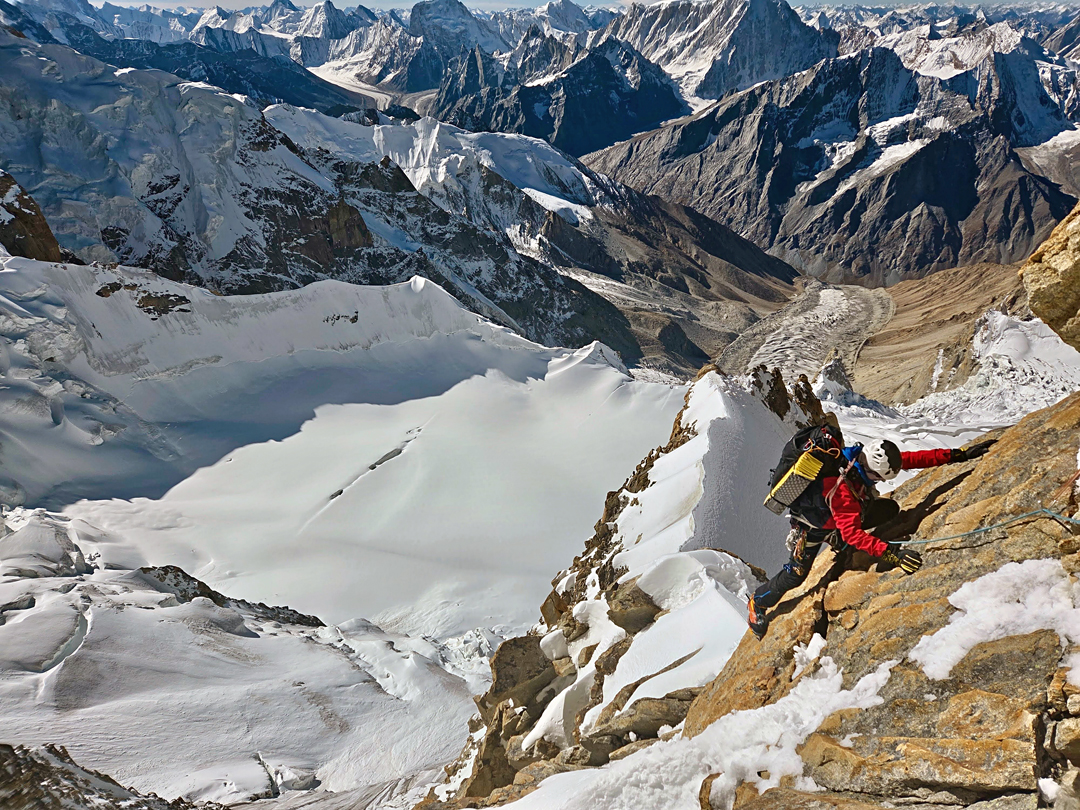 On the upper part of the south face of Chumik Kangri (6,754m), with the upper and lower glacier, which formed the approach, visible below. Most of Gharkun (6,620m) is also visible, above and slightly left of the climber.  