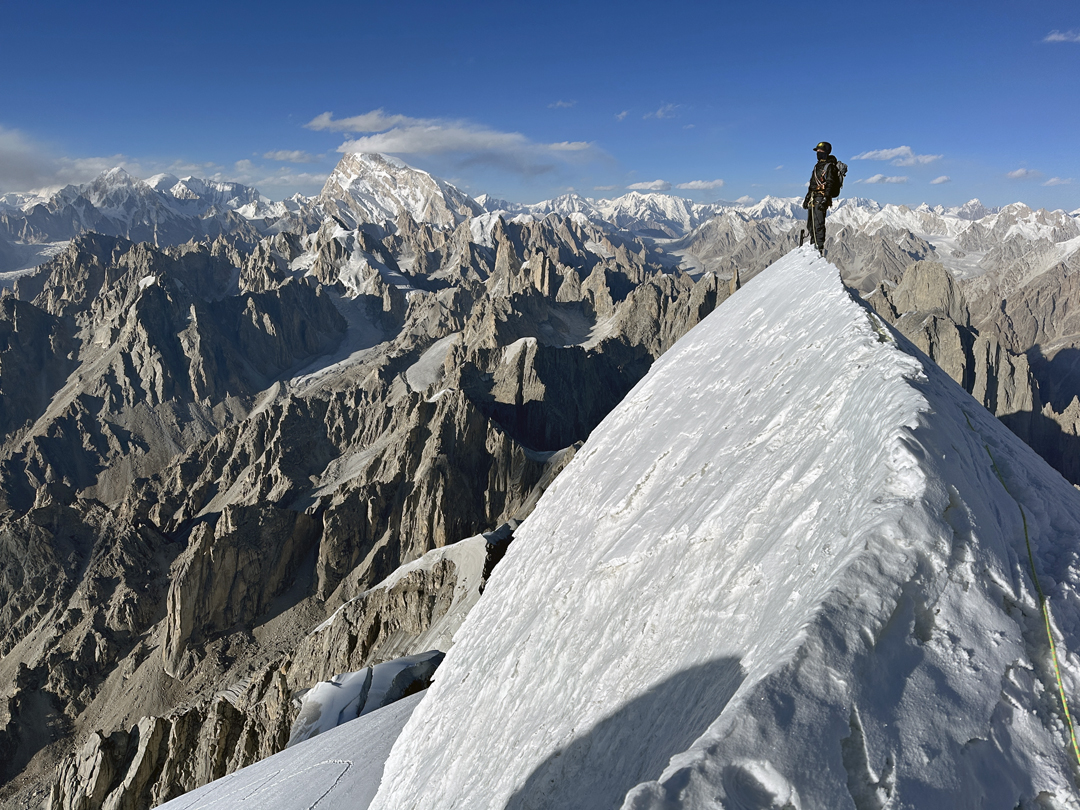Cody Winckler on the summit of Billee Kangri at the end of the third day of the climb.  The big peak in the background, to the north-northeast, is Saltoro Kangri (7,742m). 