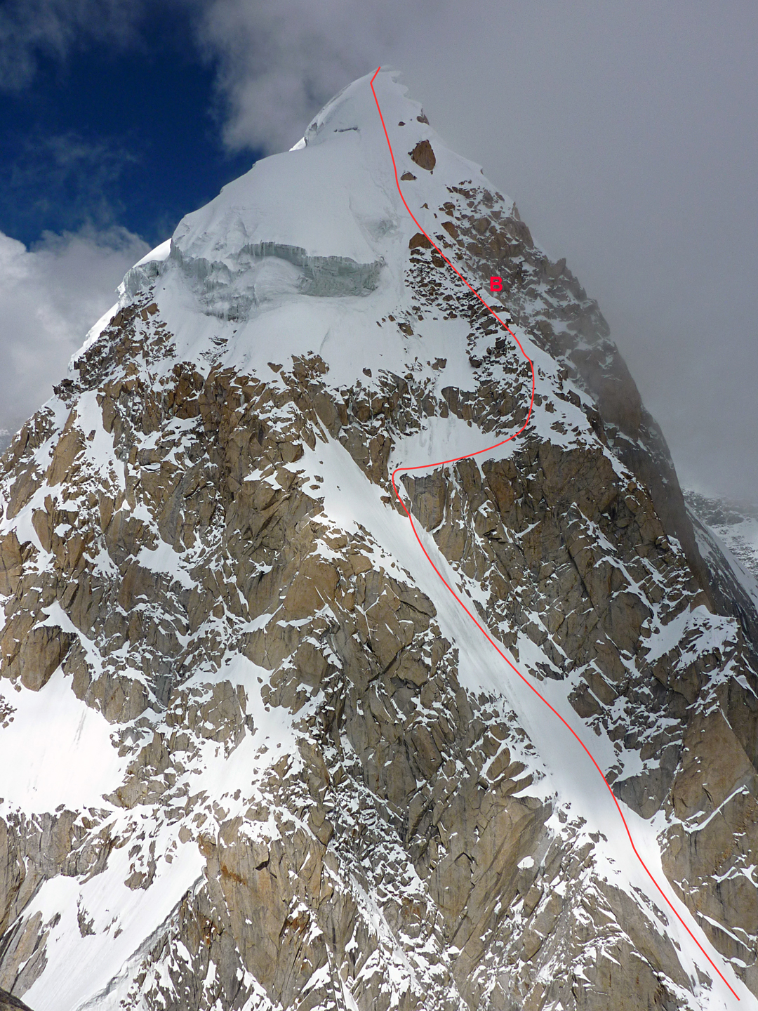 The upper southwest ridge of Hunza Peak and the line followed on the 2009 ascent after climbing the southeast face. (B) marks the bivouac site. 