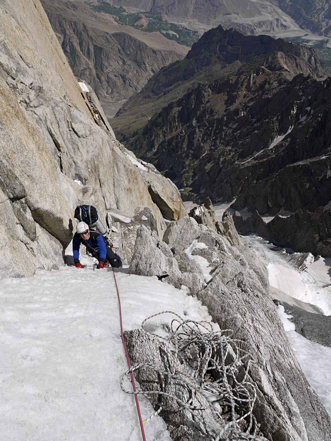 On the first ascent of Sujo on the southeast side of Hunza Peak. Julian Beerman begins the upper snow slopes. The couloir to the right descends to the Ultar Nala, which runs south to Karimabad.  