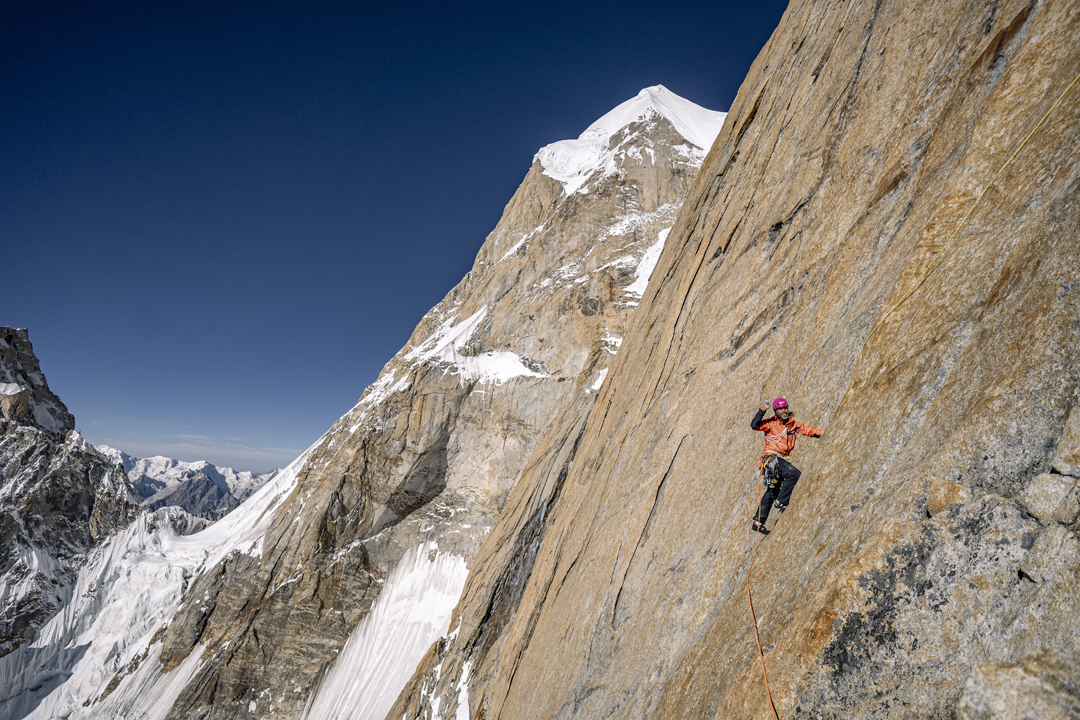 Thomas Huber starting the second pitch above the 5,880m camp on the southeast pillar of Latok III. The summit is the pointed snowy top behind. 