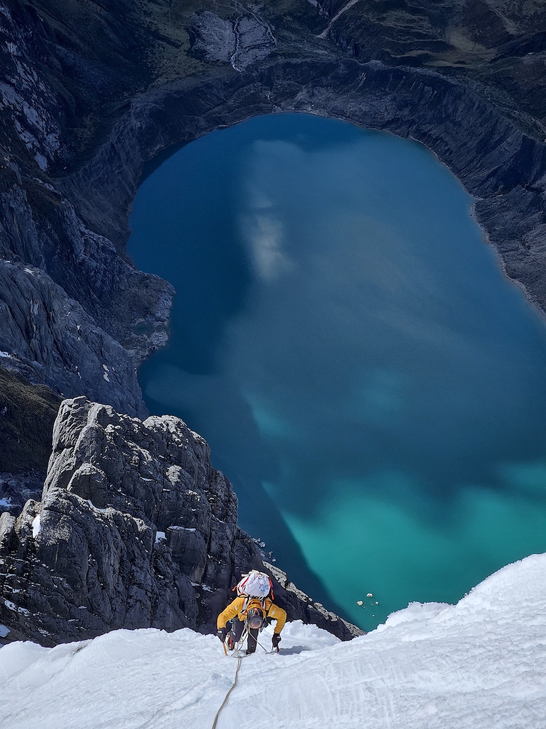 Iker Pou with Laguna Cangrajanca far below, following a pitch near the summit of Jurau A. 