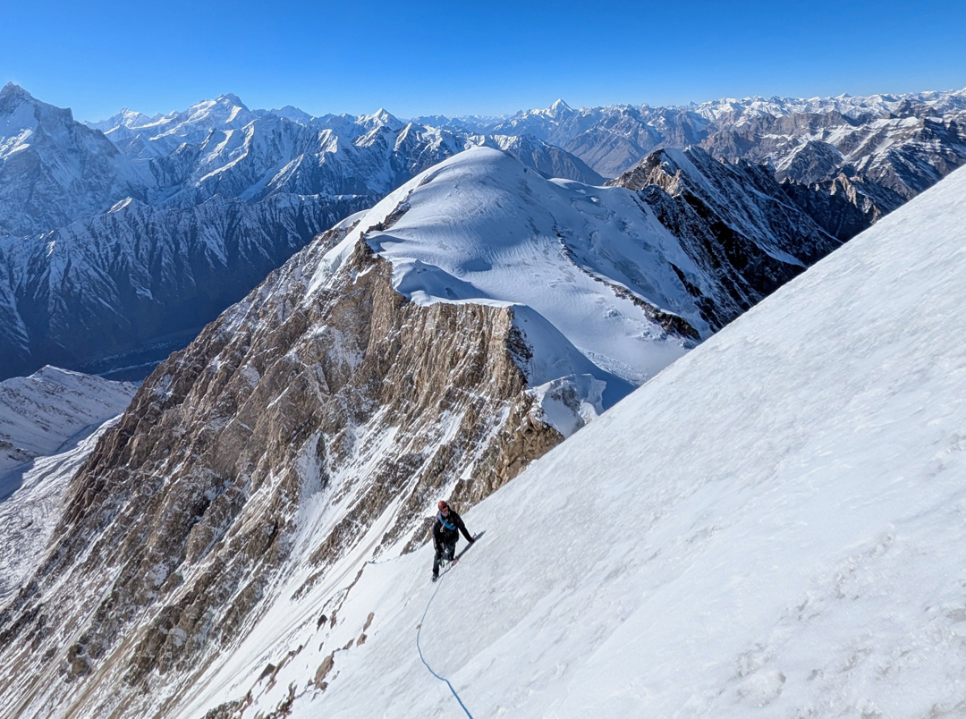 Traversing the northwest ridge of Khurdopin Sar in October 2025. Immediately behind, the rounded snow summit is Cherireen Sar (6,224m), climbed earlier in the year by Aleš Česen and Lukas Woerle.  The distant high pyramid straight behind is Karun Koh (6,977m). 