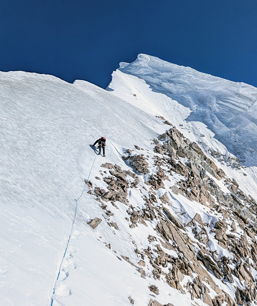 Traversing the northwest ridge toward the summit cornices of Khurdopin Sar.  
