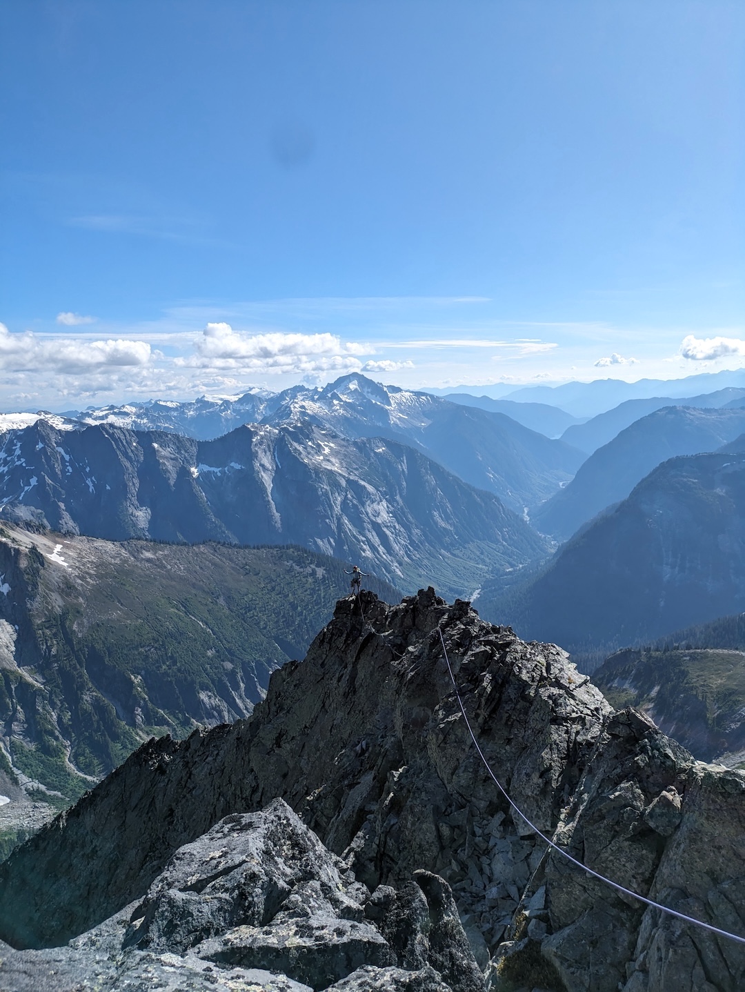 Lani Chapko following pitch 12 of The Imperfect Bypass on Whatcom Peak, with the Baker River valley behind. 