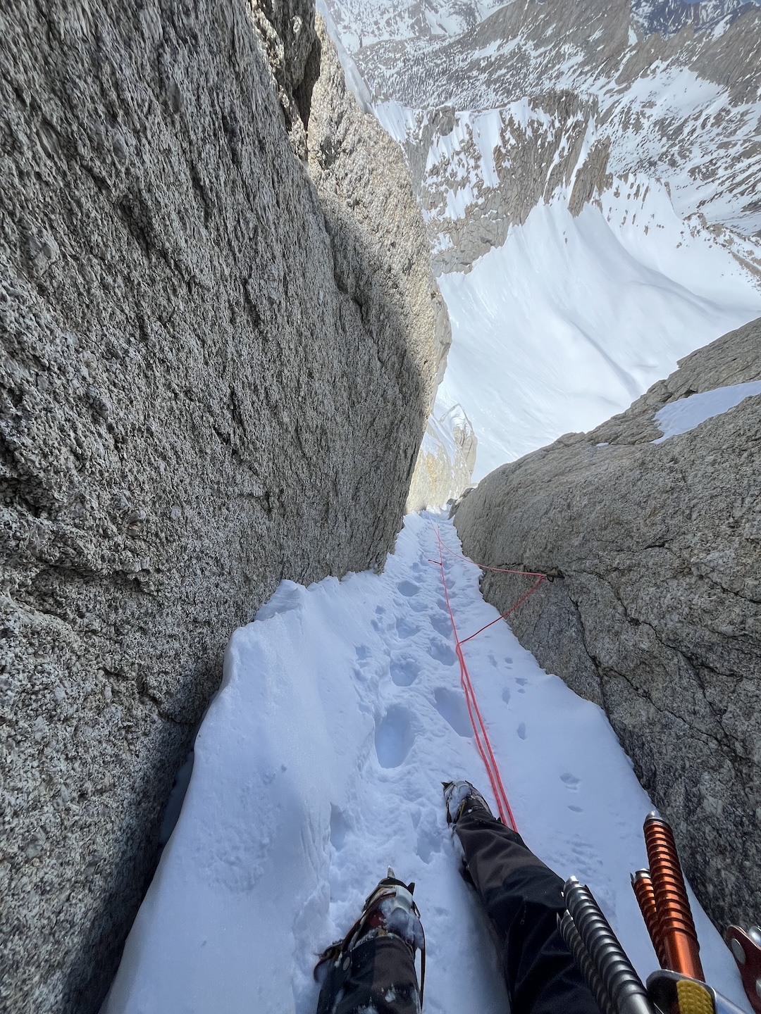 Trevor Shumaker looking down on a pitch of steep snow during the first known ascent of a route he called White Noise (800’, Steep snow, M4), on the north face of North Peak.