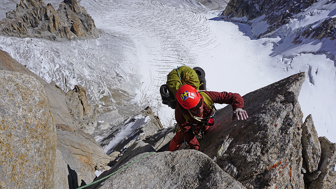 Genki Narumi high on the upper east pillar of Hasho Peak II with the West Lachit Glacier below. 