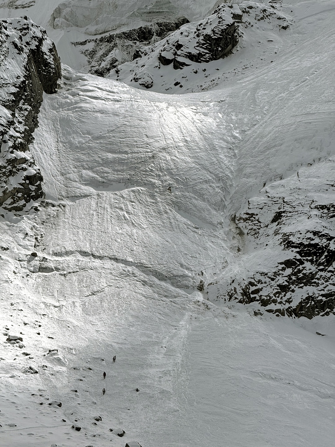 Three climbers (lower left) approaching the ice wall leading to Camp 2 on the northeast ridge of Bijora Hiunchuli. 