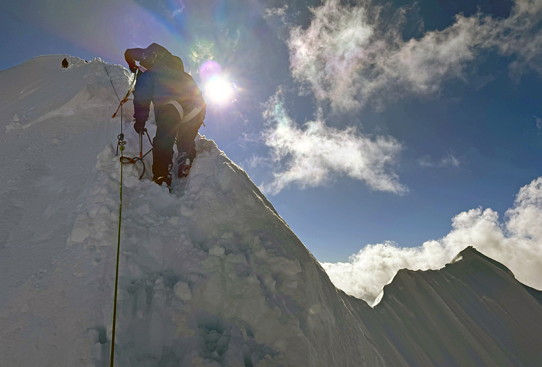 Negotiating the sharp upper northeast ridge of Bijora Hiunchuli, just before reaching the summit. On the right is the last section of the unclimbed north-northwest ridge.