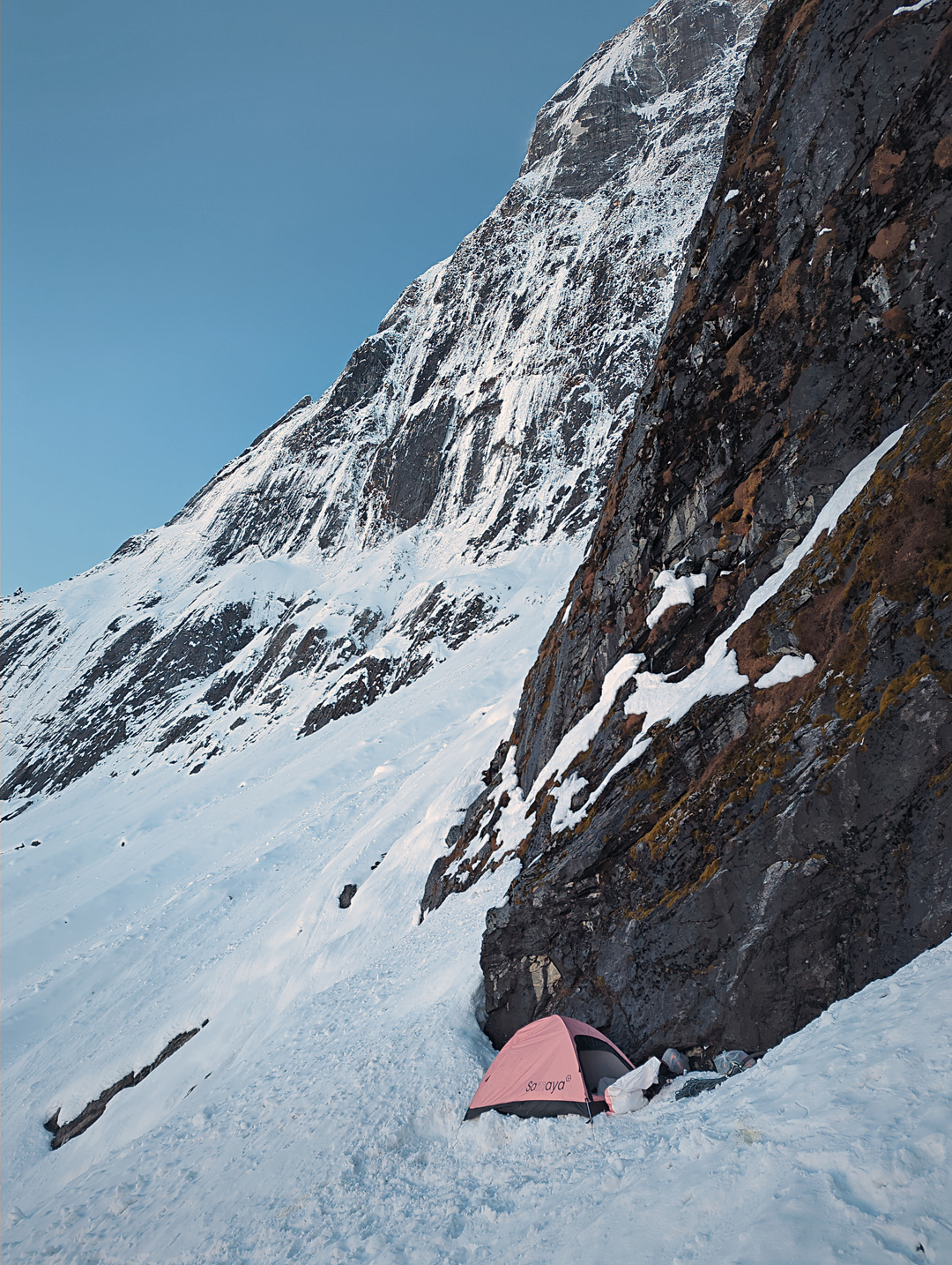 Bivouac below the foot of the northwest face of Kwangde Nup with the north pillar in profile behind.