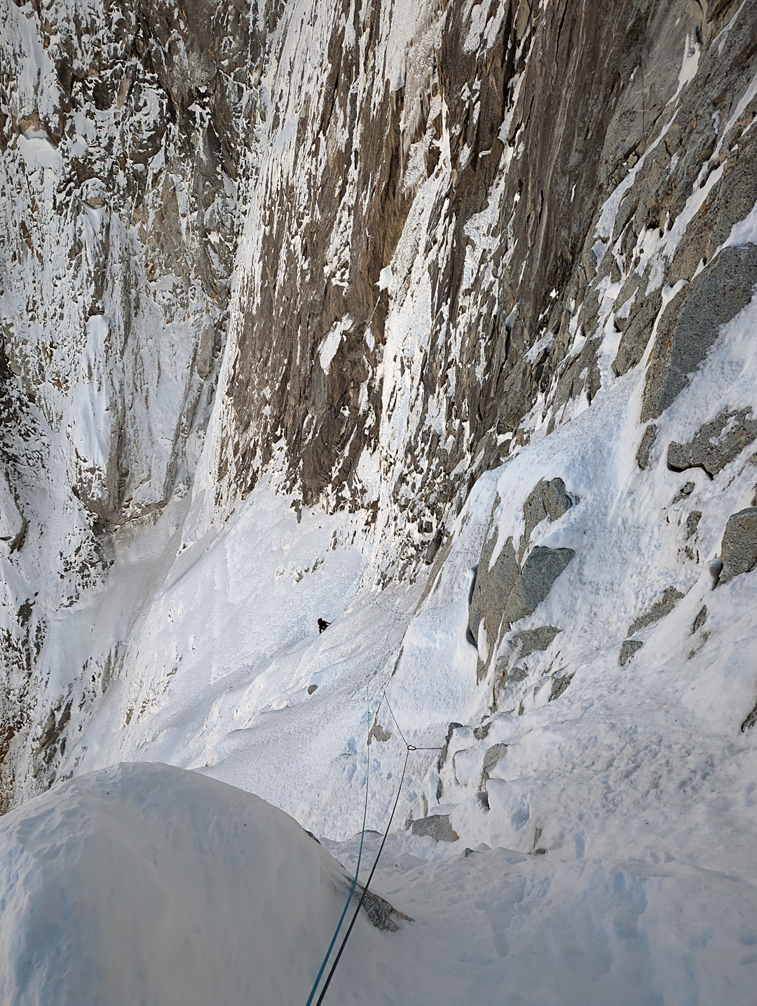 Matic Primožič on the rightward trending snow ramps of Slovo od Mladosti on the northwest face of Kwangde Nup. 