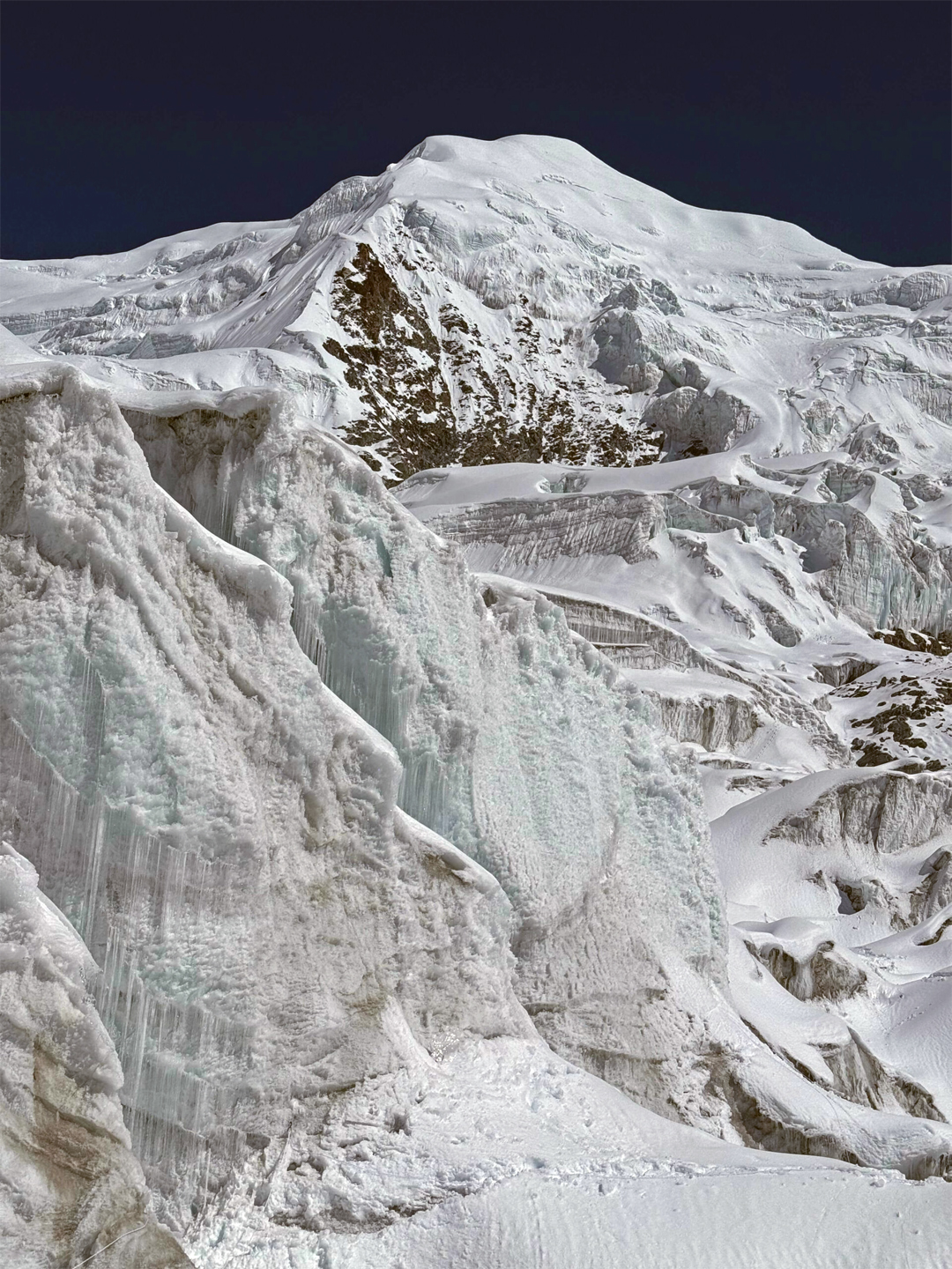 Pathibhara Southeast (6,868m) seen through the icefall of the upper Pathibhara Glacier. The southwest ridge faces the camera, angling up from left to right.