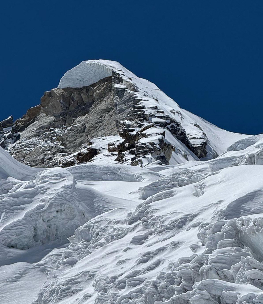 The summit of Sharphu VI from high on the east flank glacier. The top was reached via the final section of the northwest ridge (right skyline). 