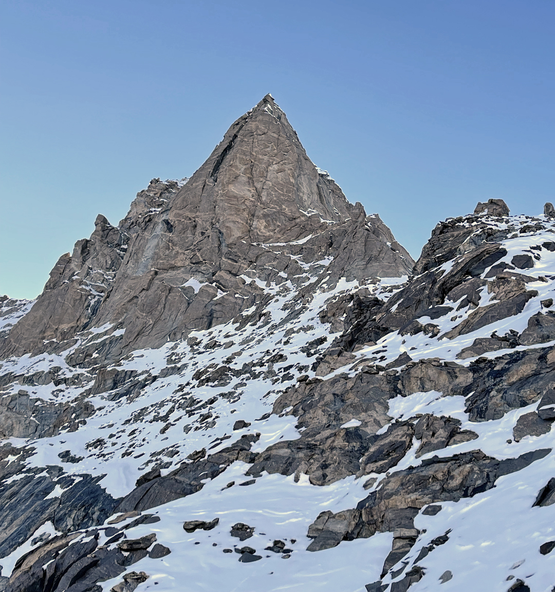 The upper rock pillar on the east face of Remalaye, reached along the flanks of the broken east ridge. The rock—whose quality was disappointing—was climbed to a point 150 meters below the summit. 