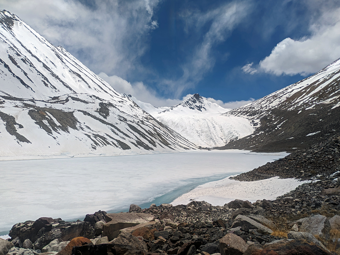 Glacial lake and northeast face of unclimbed Peak 6,000m at the head of the North Stargyuk Glacier. 