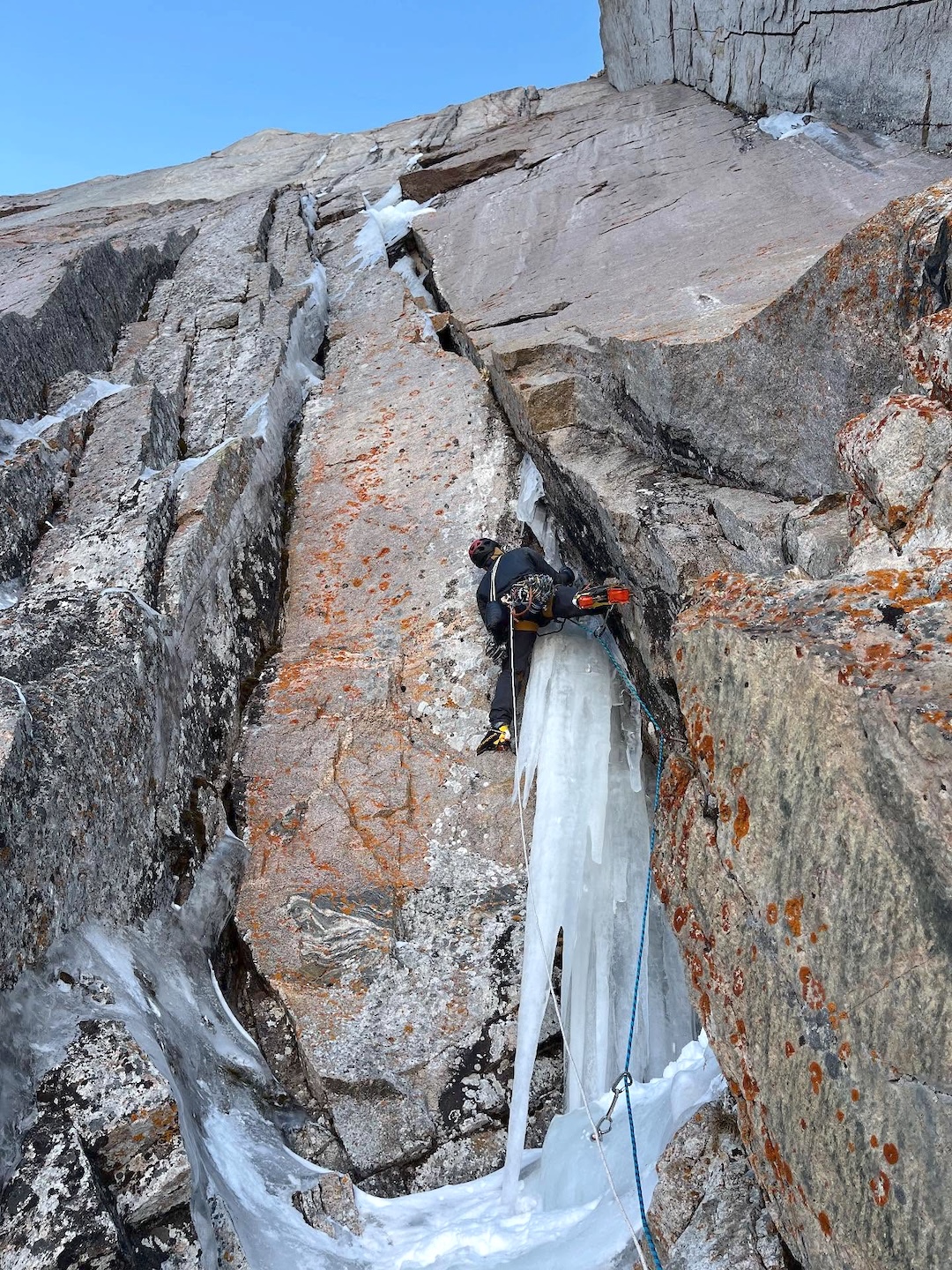 Dane Steadman starting the crux pitch of Wobbly Baknn Strips on Longs Peak. The line trended to the right above the highest visible ice to finish. Steadman returned to climb a harder finish, Baknnator Indirect (WI5 M8), angling left. 