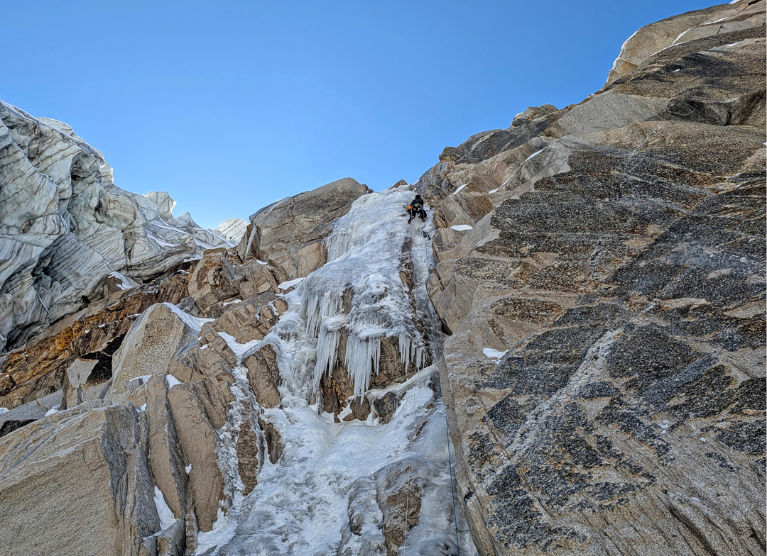 Ryan Griffiths climbs a nice ice pitch to circumvent the icefall on the northwest face of Peak 5,400m. 