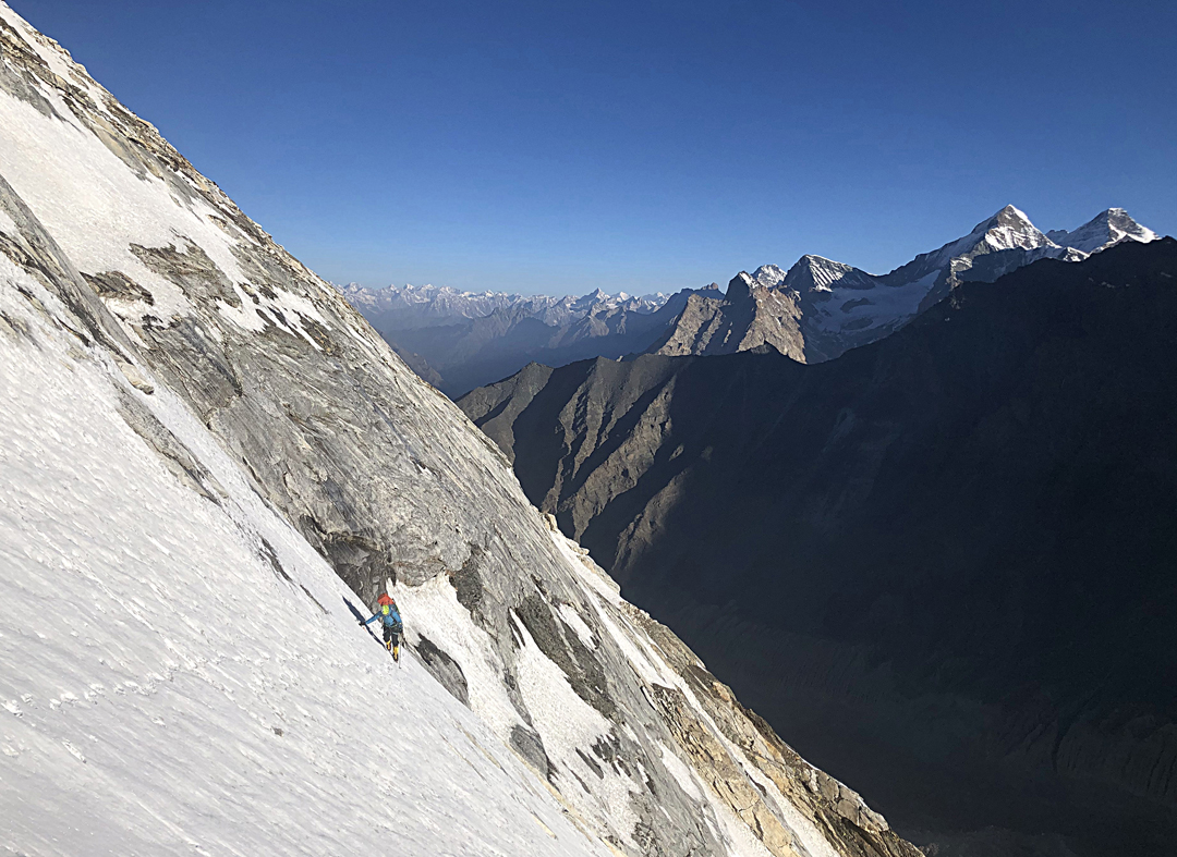 Magdalena Ritzau on the lower northeast facet on day one of the ascent of the northeast ridge of Bhagirathi II. The two high peaks to the right are Sudarshan Parvat (6,507m, left) and Chaturbhunj (6,654m). 