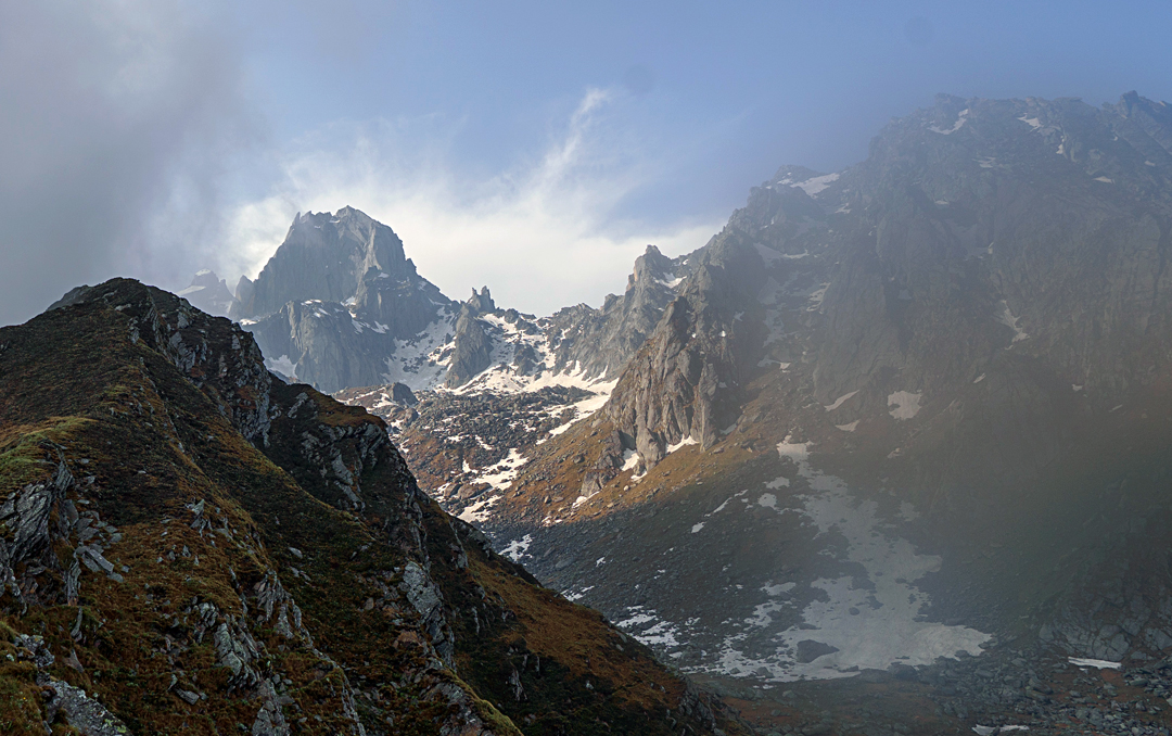 The Horn of Harsil seen from the north. The ascent started up the snowy couloir immediately right of the peak then slanted right, close to the two small rock towers, before crossing the skyline (northwest) ridge and traversing the hidden west face to finish via the west-southwest ridge. 